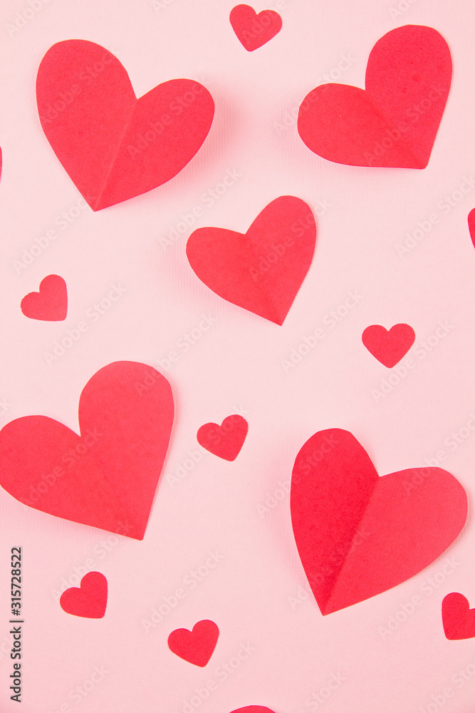Paper hearts over the pink pastel background. Abstract background with paper cut shapes. Sainte Valentine, mother's day, birthday greeting cards, invitation, celebration concept