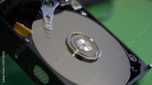 Boot read head on computer hard drive. Computer hard drive, open, read / write head and hard drive.