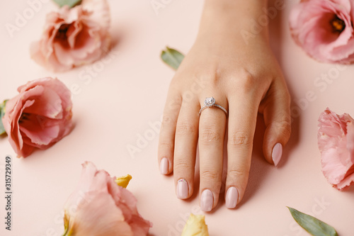 Ring on woman finger.