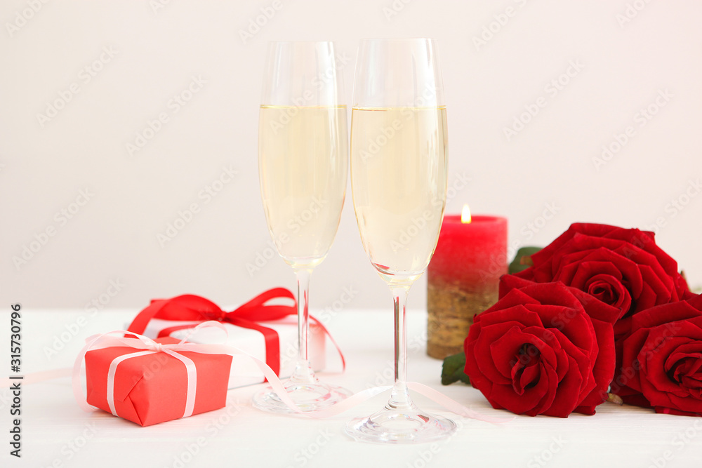 Champagne, flowers and gifts on the table. Valentine's day background. Champagne, flowers and gifts on the table. Valentine's day background.