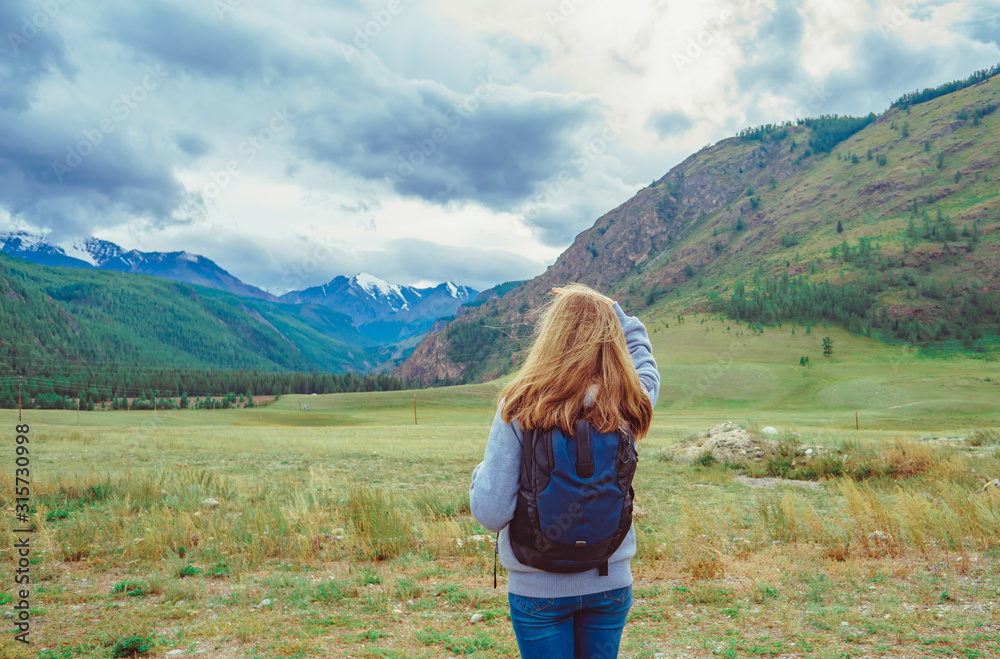 a beautiful girl stands against the background of mountains a beautiful girl stands against the background of mountains