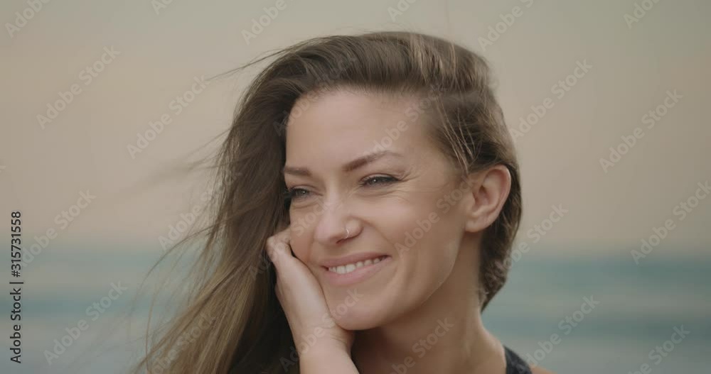 Portrait of a young woman flirting on a beach summer closeup Portrait of a young woman flirting on a beach summer closeup