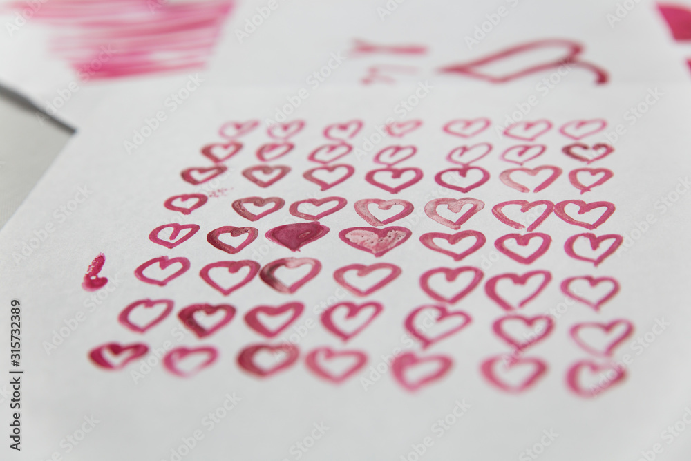 Greeting card for Valentine's Day. Pink hearts painted with watercolor paints Greeting card for Valentine's Day. Pink hearts painted with watercolor paints