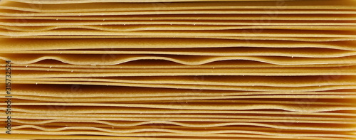 Uncooked Italian pasta lasagne background and texture, top view