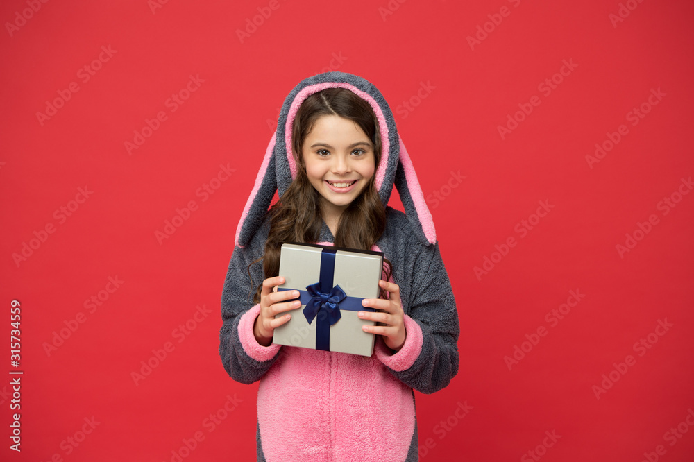 Gift perfect for holidays. Happy child hold gift box. Little girl in pyjamas with gift. Gift for Christmas or New year. Boxing day. Birthday anniversary. Special occasion present or purchase Gift perfect for holidays. Happy child hold gift box. Little girl in pyjamas with gift. Gift for Christmas or New year. Boxing day. Birthday anniversary. Special occasion present or purchase