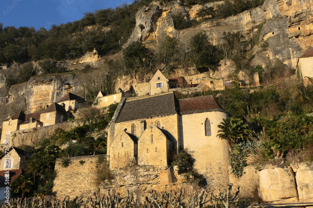 Medieval church of La Roque Gageac in the Dordogne, France - set amongst towering cliffs 