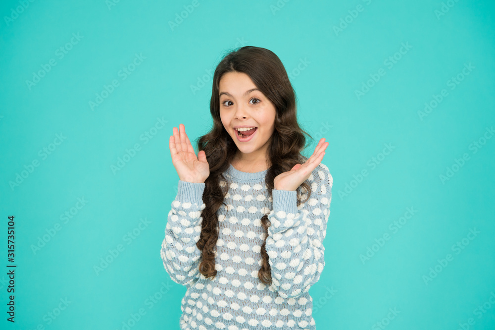 Smiling small girl with long hair. Beauty and health. It s her happy time. Childhood concept. International childrens day. Child care. Happy childhood. Emotional girl. Little girl blue background Smiling small girl with long hair. Beauty and health. It s her happy time. Childhood concept. International childrens day. Child care. Happy childhood. Emotional girl. Little girl blue background