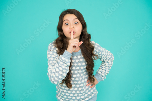Keep secret. Little girl keep index finger by her lips. Be silent. Rumor legend and myth. Confidential information and secret. Secret story concept. Child surprised face just told her secret