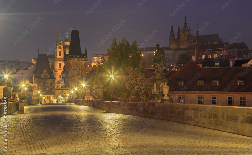 Prague - The St. Nicholas church from Charles Bridge in the morning dusk.