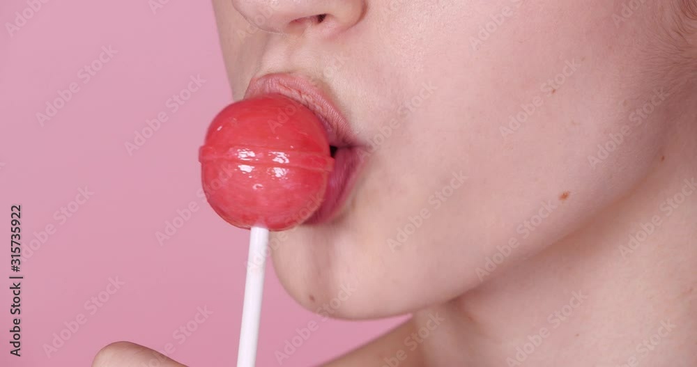 Beautiful young woman with sweet lollipop, closeup