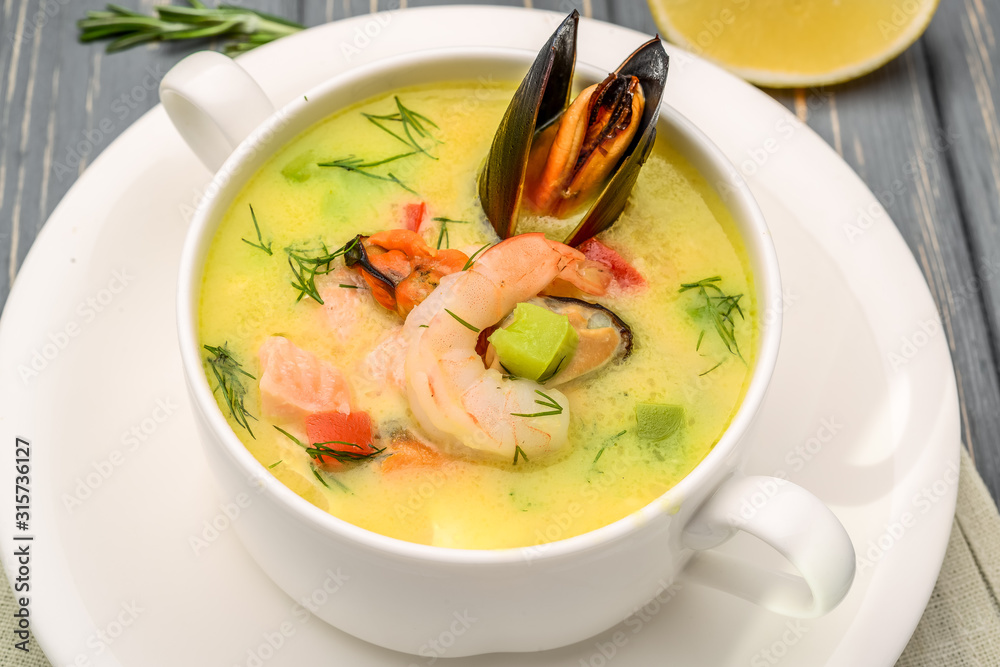 Seafood soup, on a wooden table, with shrimp Seafood soup, on a wooden table, with shrimp