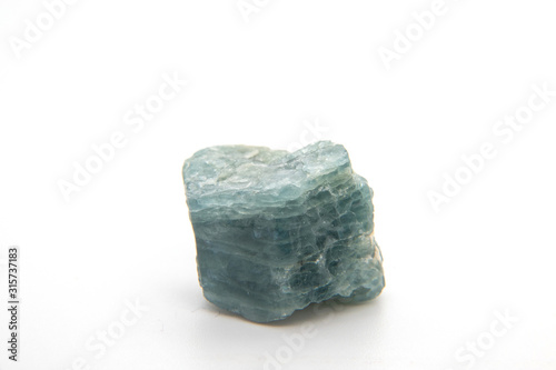 Rough and uncut pile of Apatite gemstones in a lovely blueish green color.