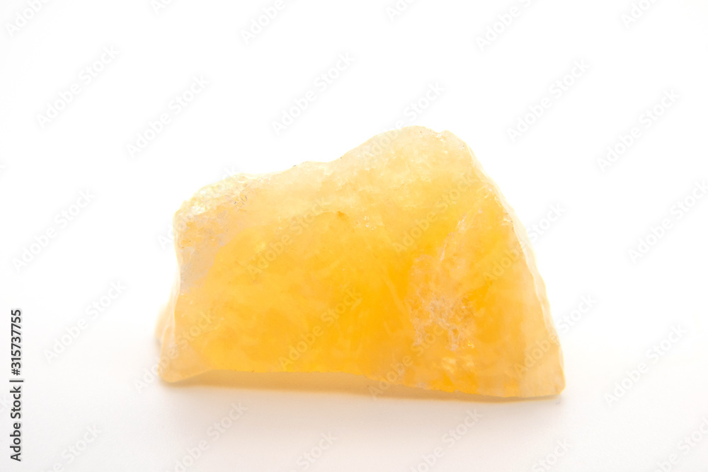 macro shooting of natural mineral rock specimen - raw tea Calcite stone on white marble from Mexico macro shooting of natural mineral rock specimen - raw tea Calcite stone on white marble from Mexico