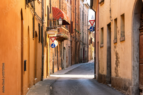 Narrow medieval street in Ferrara, Italy © skostep