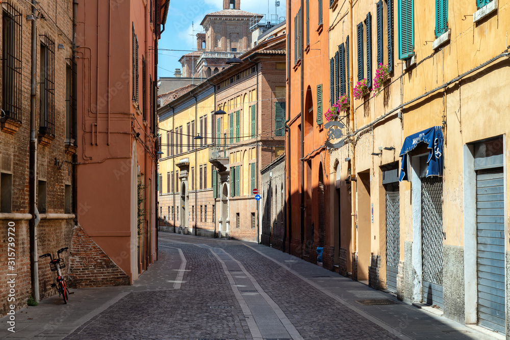 Narrow medieval street in Ferrara, Italy