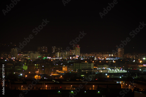Night 4k city skyline. Road junction traffic. Lights flicker in windows.