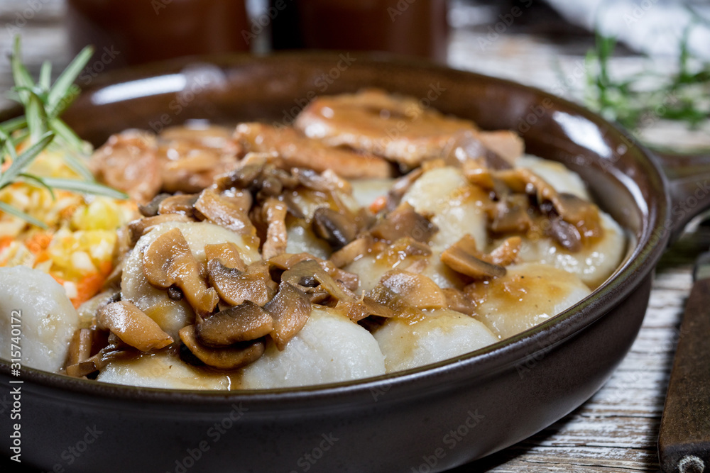 Stewed pork chop in a bright mushroom sauce.
