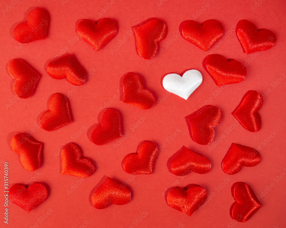 Red and white hearts on a red background. Valentine's day holiday. Symbol of love.