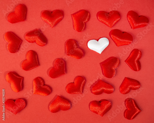Red and white hearts on a red background. Valentine s day holiday. Symbol of love.