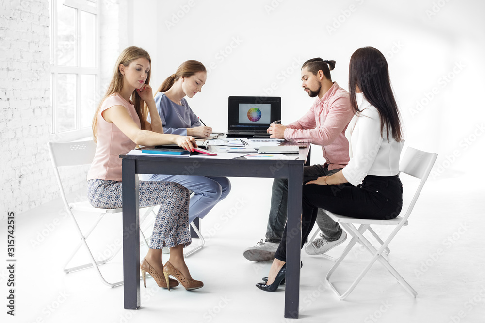 Serious colleagues work in the office. The concept of entrepreneurs, success, making money and work. Serious colleagues work in the office. The concept of entrepreneurs, success, making money and work.