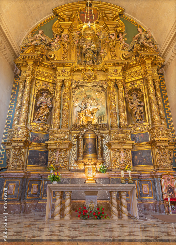 PALMA DE MALLORCA, SPAIN - JANUARY 29, 2019: The baroque main altar with the statue of St. Teresa of Avila in the church Iglesia de Santa Maria Magdalena.