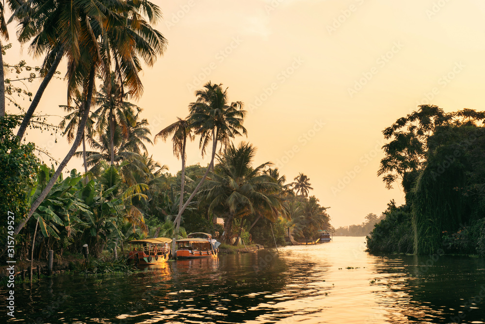 Alleppey backwaters with local boat on sunrise