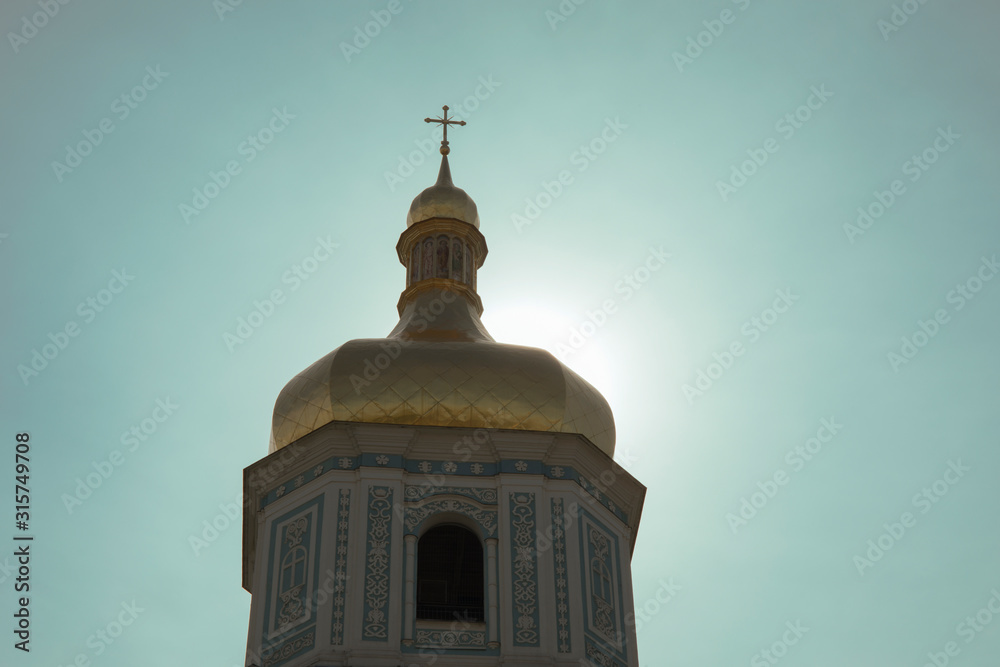 Church silhouette and sun behind the church tower Church silhouette and sun behind the church tower