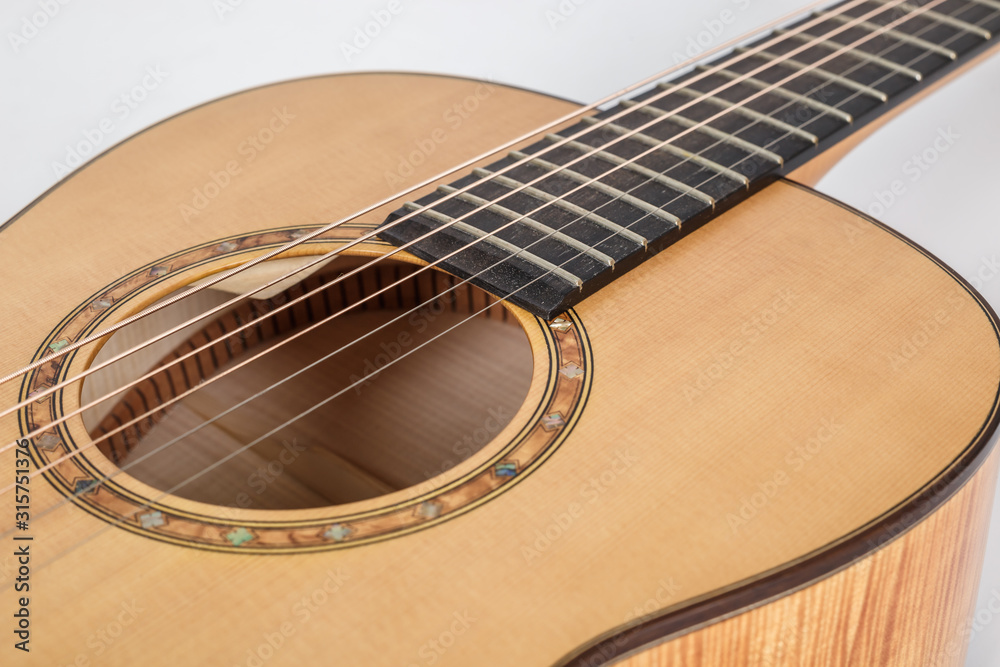 wood texture of lower deck of six strings acoustic guitar on white background. guitar shape wood texture of lower deck of six strings acoustic guitar on white background. guitar shape