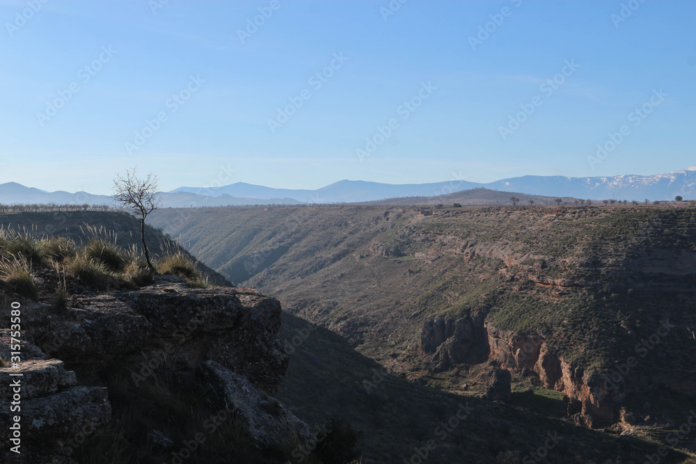 Scenic view of the Gor river valley and Sierra Nevada mountains on the background, Spain