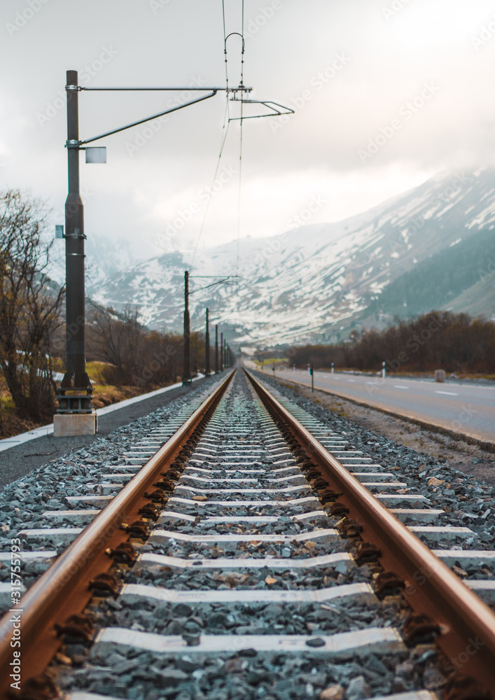 straight railway tracks in alps