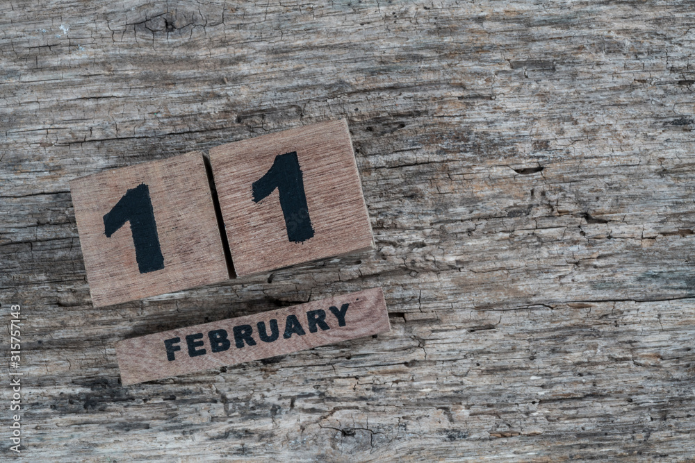 cube calendar for february on wooden background with copy space cube calendar for february on wooden background with copy space