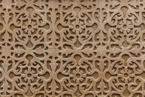 Geometrical pattern on wall. Decorative detail with flower elements