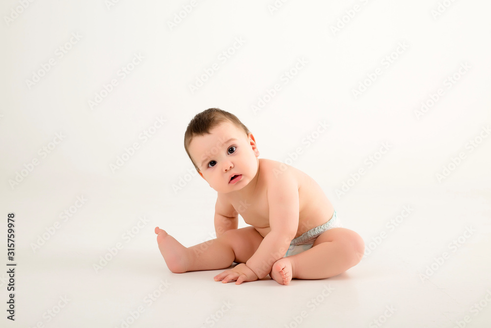 healthy baby boy 9 months old sitting on a white background isolate, space for text healthy baby boy 9 months old sitting on a white background isolate, space for text