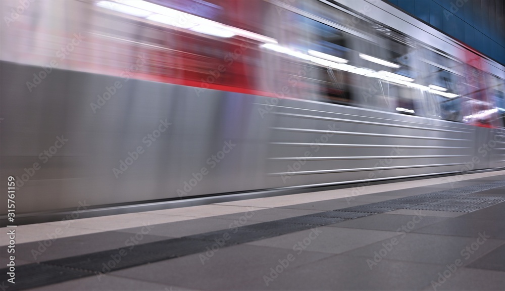 Dynamic movement of departing train in red and silver color Dynamic movement of departing train in red and silver color