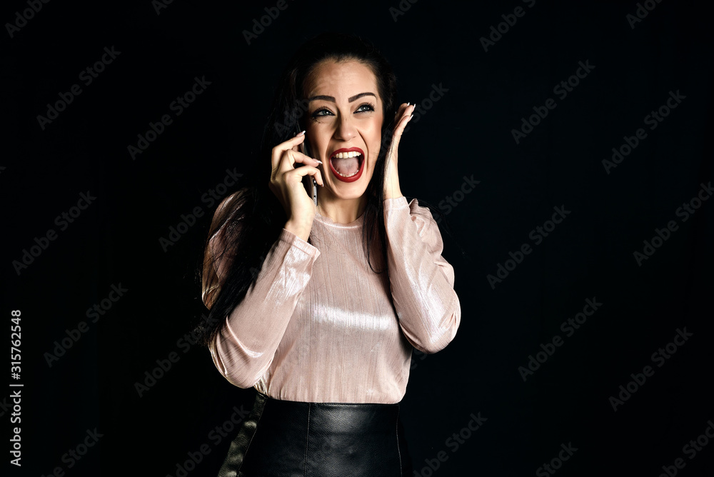 Young woman with long hair calling with her smarthphone to her mother. family concept Young woman with long hair calling with her smarthphone to her mother. family concept