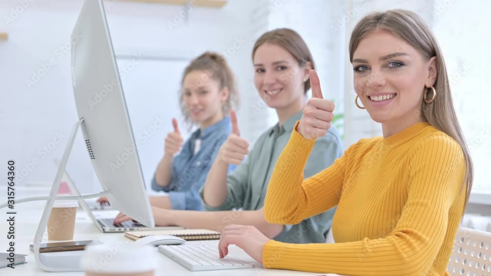 Ambitious Young Designer Team showing Thumbs Up Ambitious Young Designer Team showing Thumbs Up
