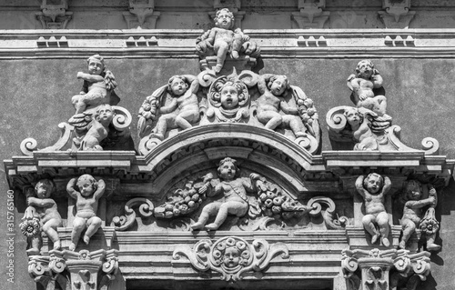 CATANIA, ITALY - APRIL 8, 2018: The detail of top part of window from Palazzo Biscari. © Renáta Sedmáková