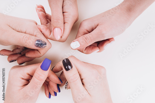 Delicate girlish hands with a stylish manicure in the form of a circle. 
