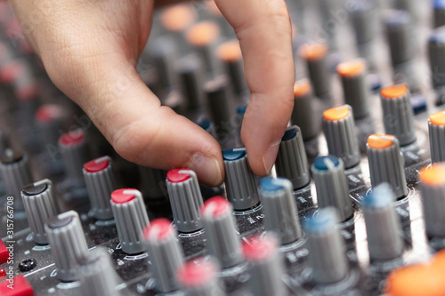 Close-up of a mixing console, hand equalizing audio channels. Professional recording studio. Working in recording studio .