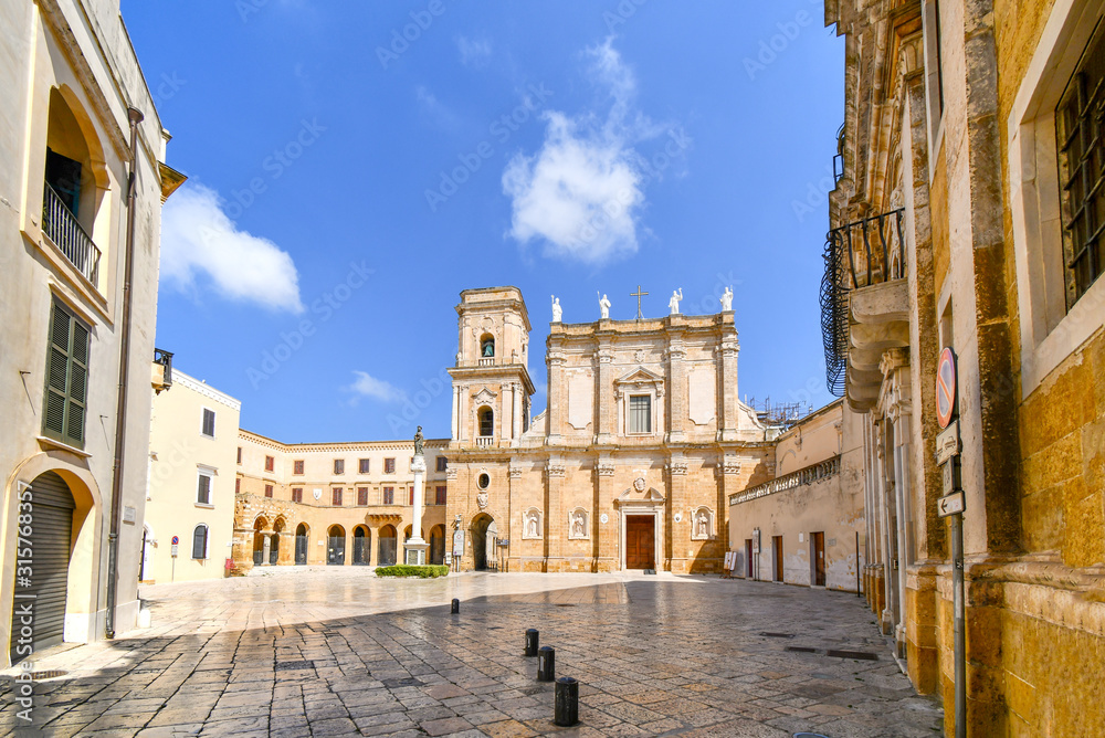 The piazza courtyard in front of St. John the Baptist Church also known as the Duomo Cathedral in the seaside town of Brindisi, Italy.
