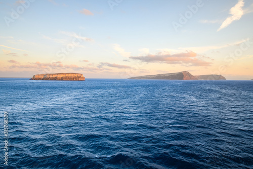 Sunrise on the Aegean Sea with views of Aspronisi or White Island, and other islands of Nea and Palea Kameni photo