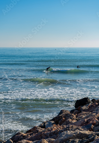 Men surfing in the Mediterranean Sea