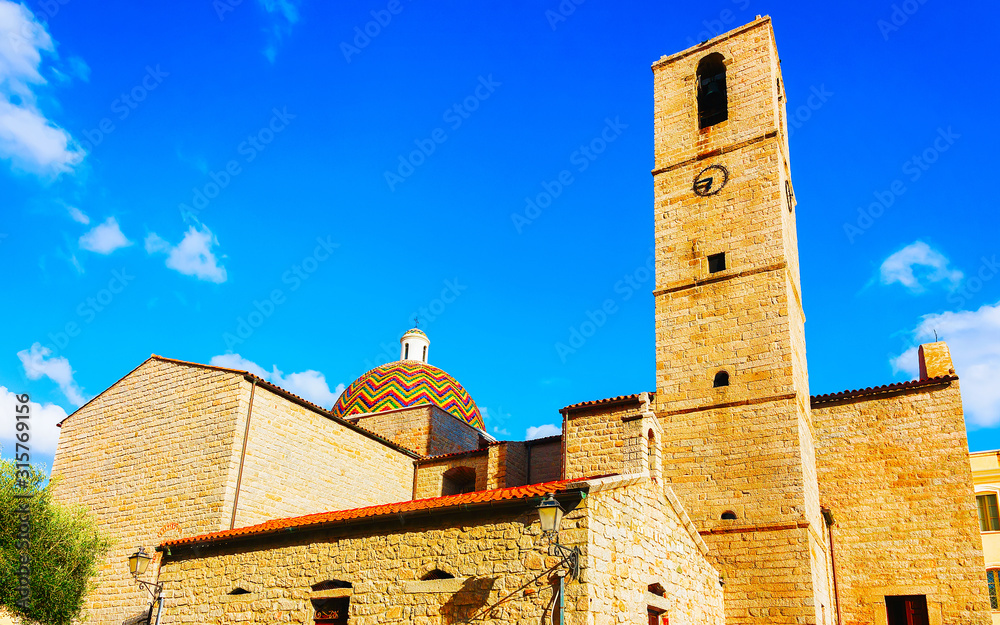 Cupola of Chiesa di San Paolo Apostolo Church in Old city of Olbia on Sardinia Island in Italy. Cathedral in Sardegna. Blue sky with white clouds on background. Mixed media.