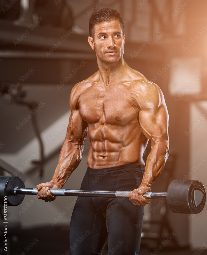 Muscular Men, Bodybuilder Lifting Weights in the Gym