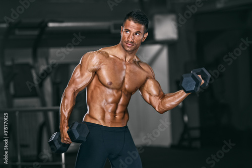 Muscular Men, Bodybuilder Lifting Weights in the Gym