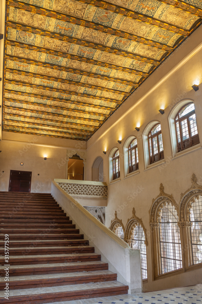 ZARAGOZA, SPAIN - MARCH 2, 2018: The hall and stairs of La Aljaferia palace with the painted ceiling.