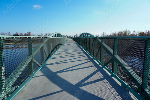 Walking bridge over river to other side, outdoor activities. © udorn_1976