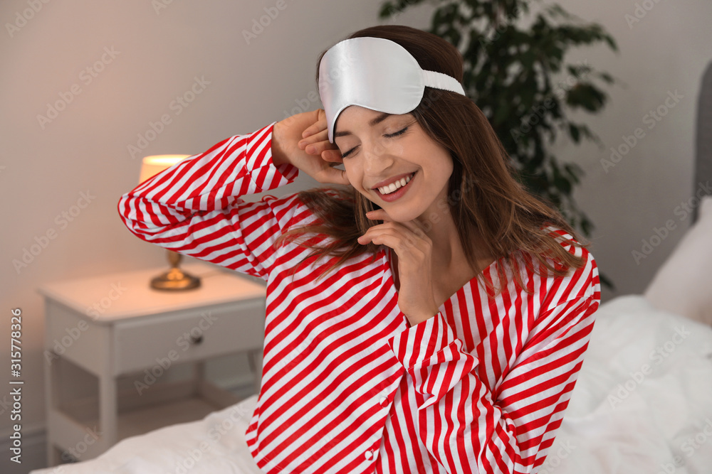 Beautiful woman wearing pajamas and sleep mask indoors. Bedtime Beautiful woman wearing pajamas and sleep mask indoors. Bedtime