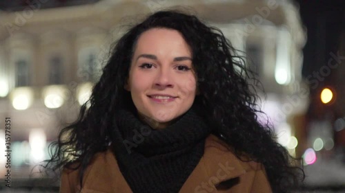 Wallpaper Mural Portrait of a Beautiful Young Woman at Night in the City. young woman licking lips. SLOW MOTION 4K. Attractive Happy Girl looking to camera. Blurred Night Busy Street lights background Torontodigital.ca