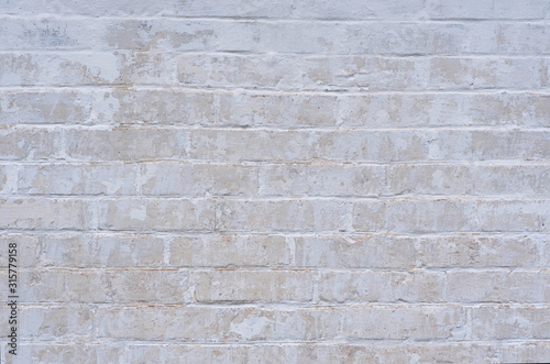 White weathered wall, peeling wall, made of silicate brick. Texture.